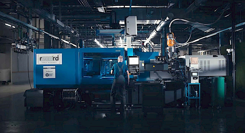 Operating a PET injection moulded record press.