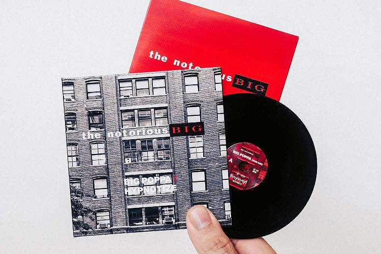 Black tiny vinyl record with printed gatefold and inner sleeve
